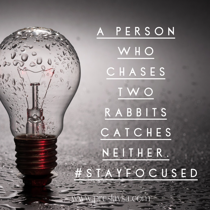 A light bulb with a quote that says a person who hates two rabbits catches neither #stayfocused 